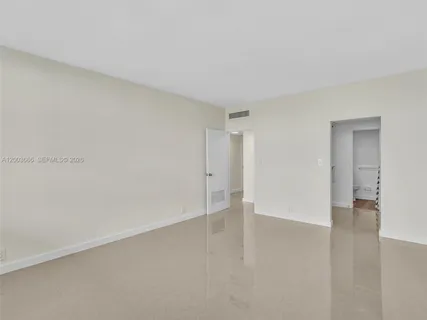 a bathroom with a shower and a glass door