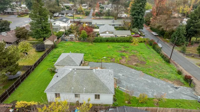 an aerial view of a house with garden space and street view