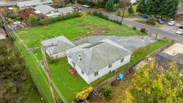 an aerial view of a house with a yard