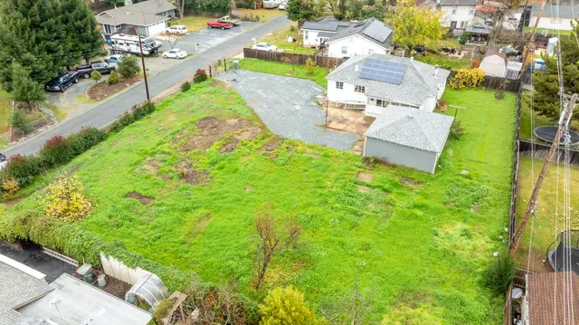 an aerial view of a house with garden space and street view