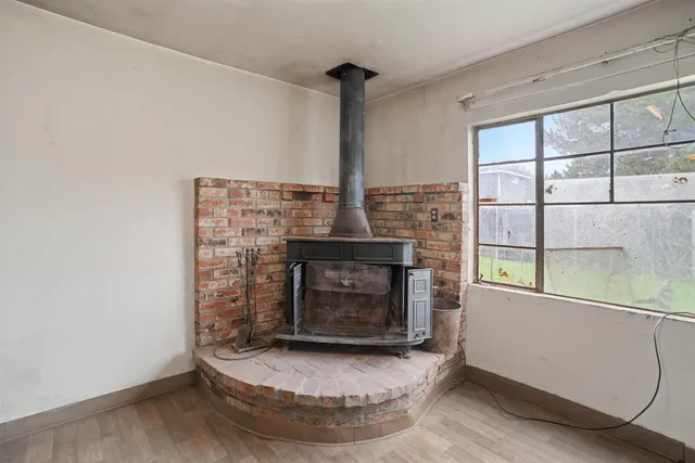 a living room with fireplace and a fireplace