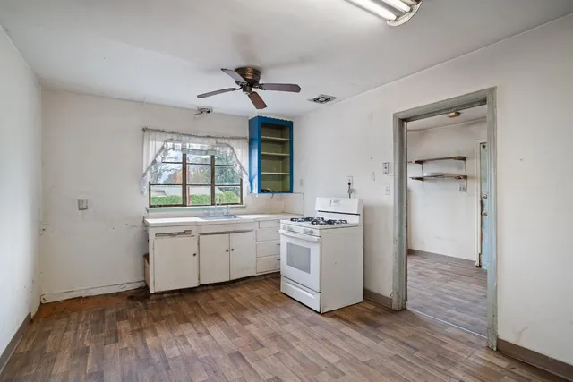 a kitchen with a refrigerator and a stove top oven