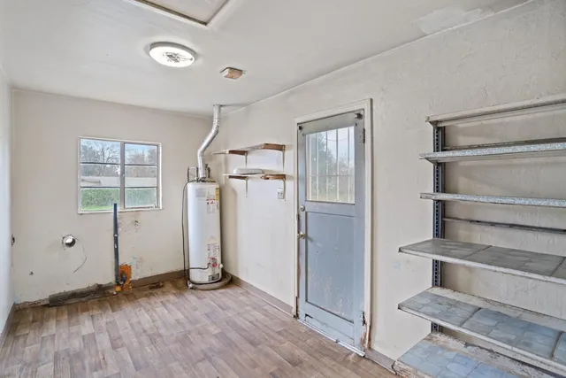 a view of empty room with wooden floor and windows