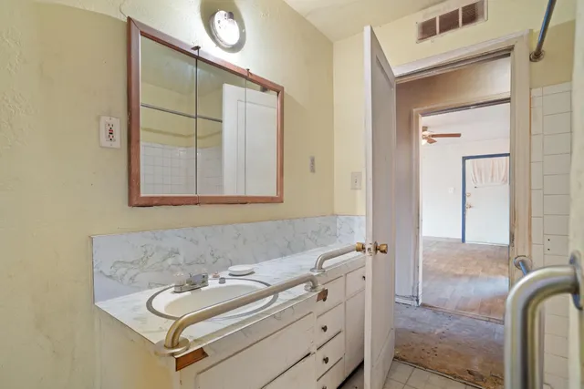 a bathroom with a tub and a mirror