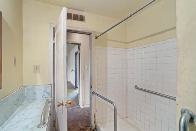 a bathroom with a shower and a sink