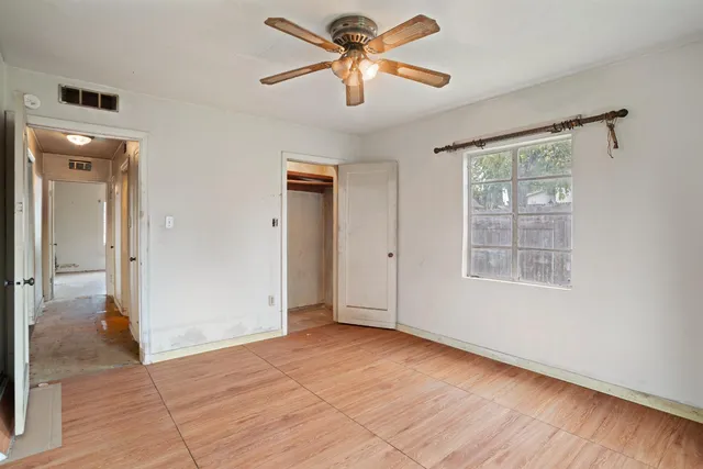 a view of a livingroom with a ceiling fan and window