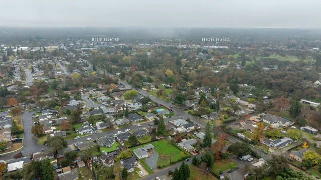 an aerial view of house with yard and mountain view in back