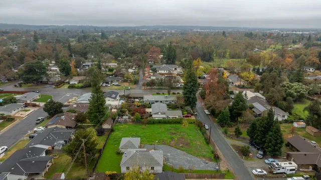 an aerial view of lake and residential houses with outdoor space