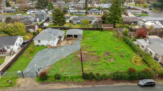 an aerial view of a house with a yard