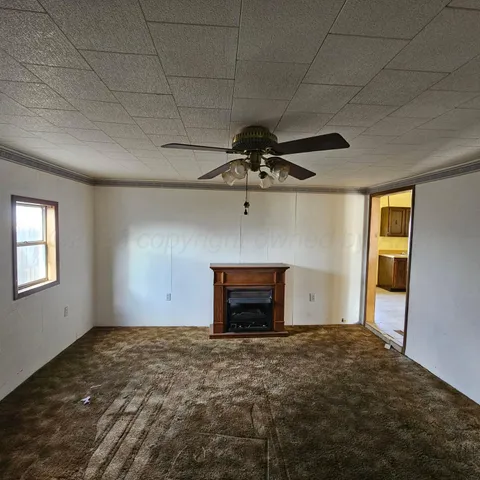 a view of empty room with a fireplace