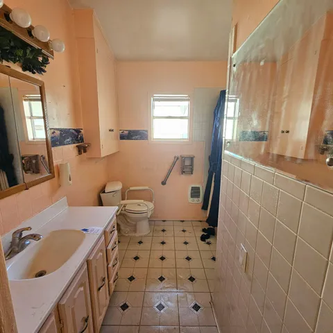 a bath room with a sink and a mirror