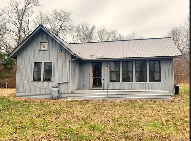 a house with trees in the background