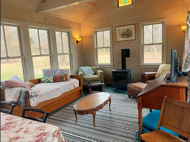 a living room with furniture a window and a fireplace