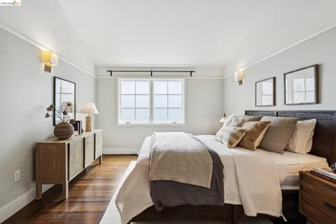 a bedroom with a bed and a large window