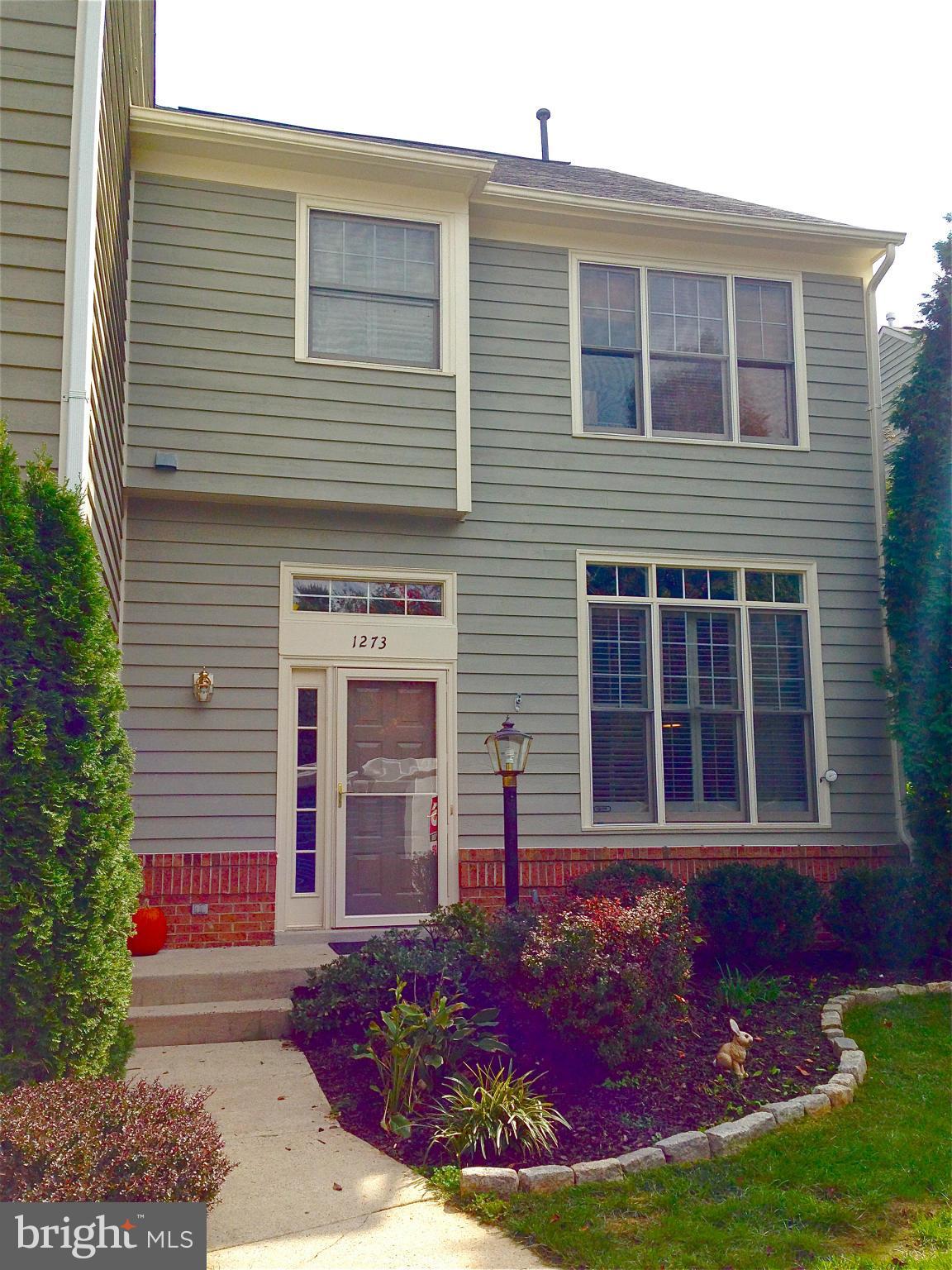 1273 Weatherstone Court Reston, VA 20194 - Photo 1 of 24 a front view of a house with garden