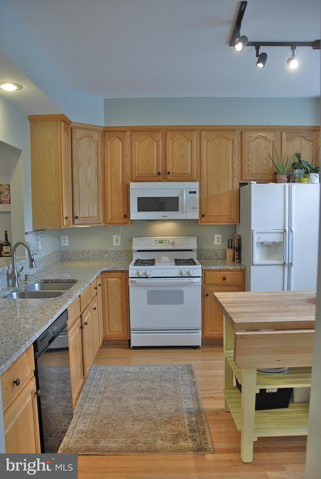 1273 Weatherstone Court Reston, VA 20194 - Photo 3 of 24 a kitchen with a stove a sink and a refrigerator