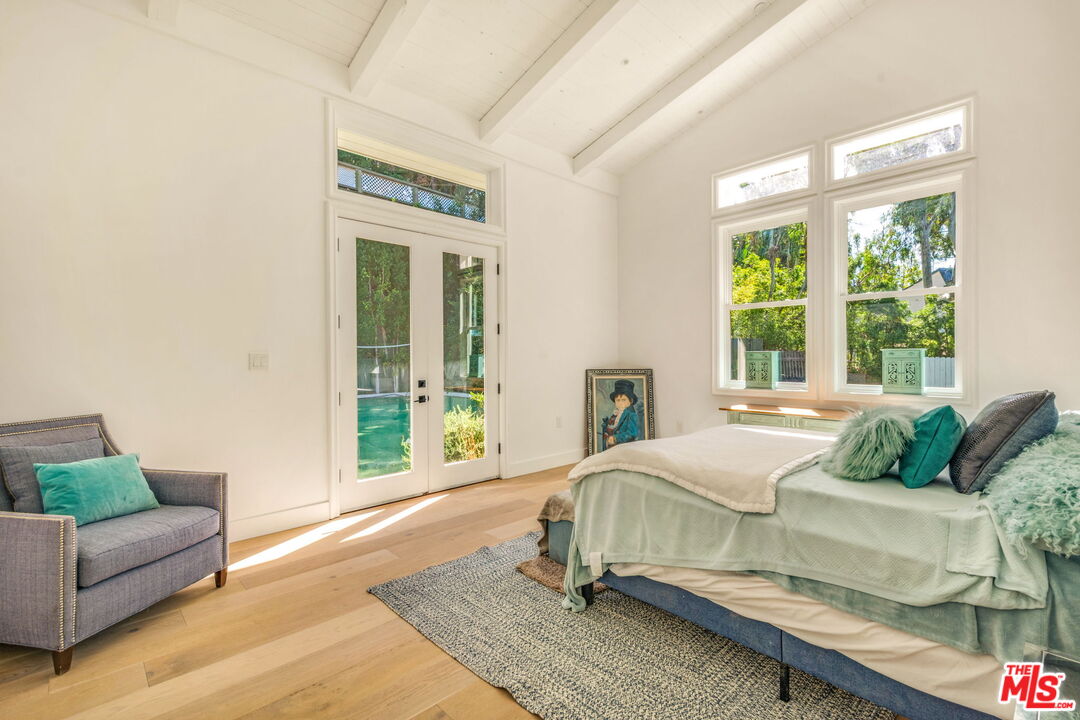 9669 Oak Pass Road Beverly Hills, CA 90210 - Photo 23 of 37 a living room with a bed furniture and a window