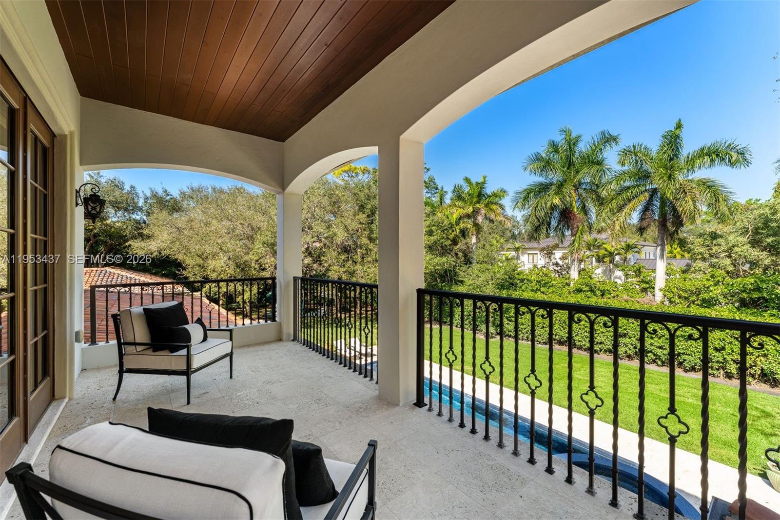 5865 Southwest 96th Street Pinecrest, FL 33156 - Photo 11 of 32 a balcony with furniture and a potted plant