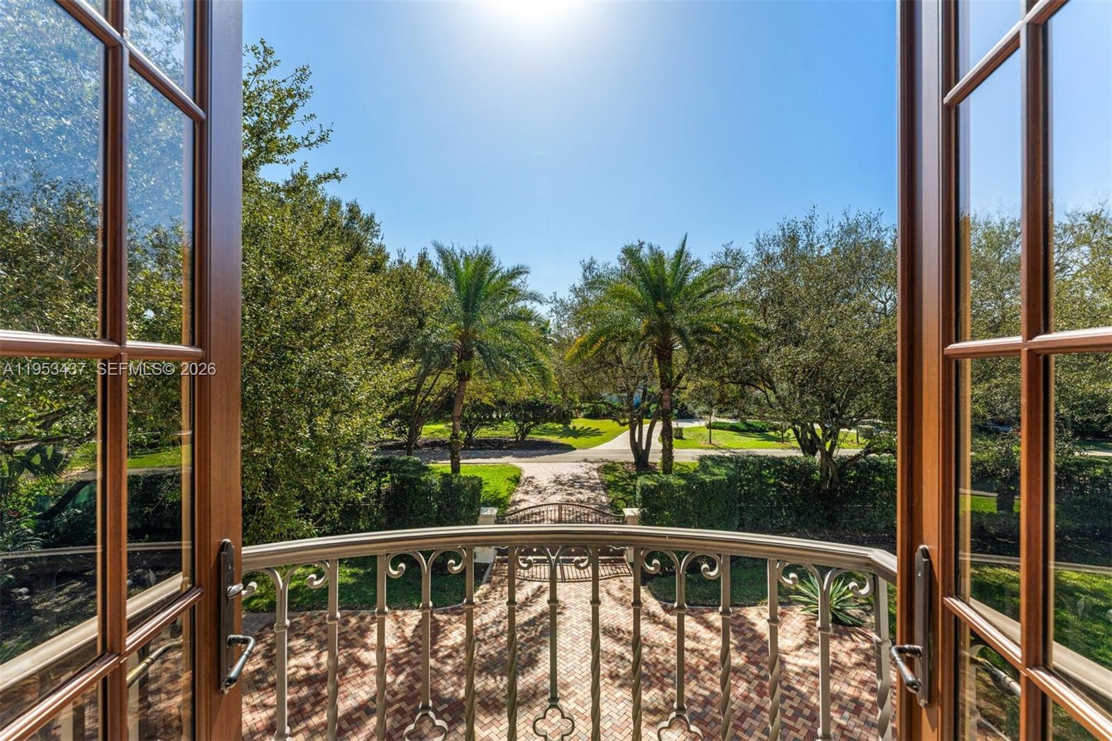 5865 Southwest 96th Street Pinecrest, FL 33156 - Photo 26 of 32 a view of a balcony with floor to ceiling windows with wooden fence