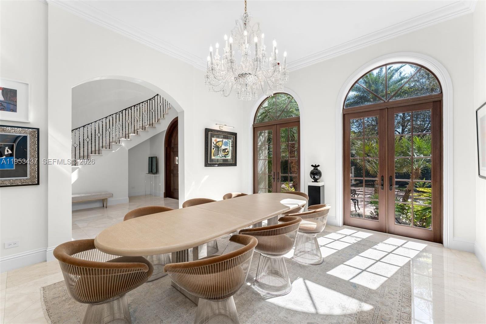 5865 Southwest 96th Street Pinecrest, FL 33156 - Photo 5 of 32 a view of a dining room with furniture wooden floor chandelier and glass door