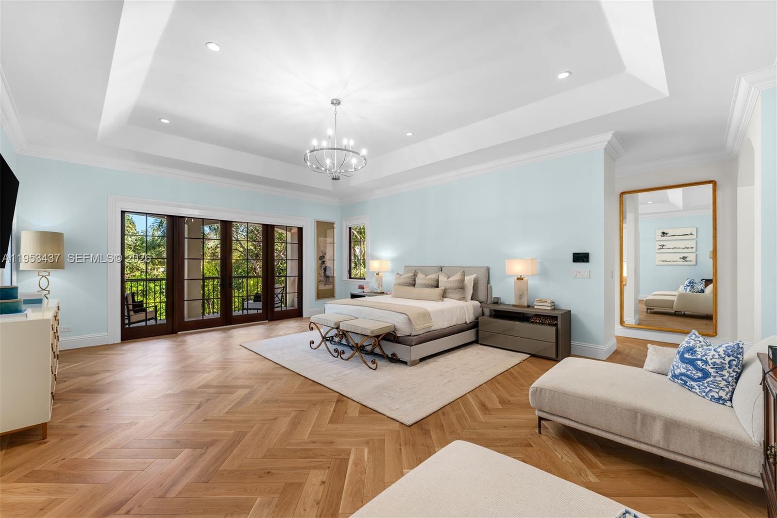 5865 Southwest 96th Street Pinecrest, FL 33156 - Photo 8 of 32 a spacious bedroom with a bed a couch and a chandelier