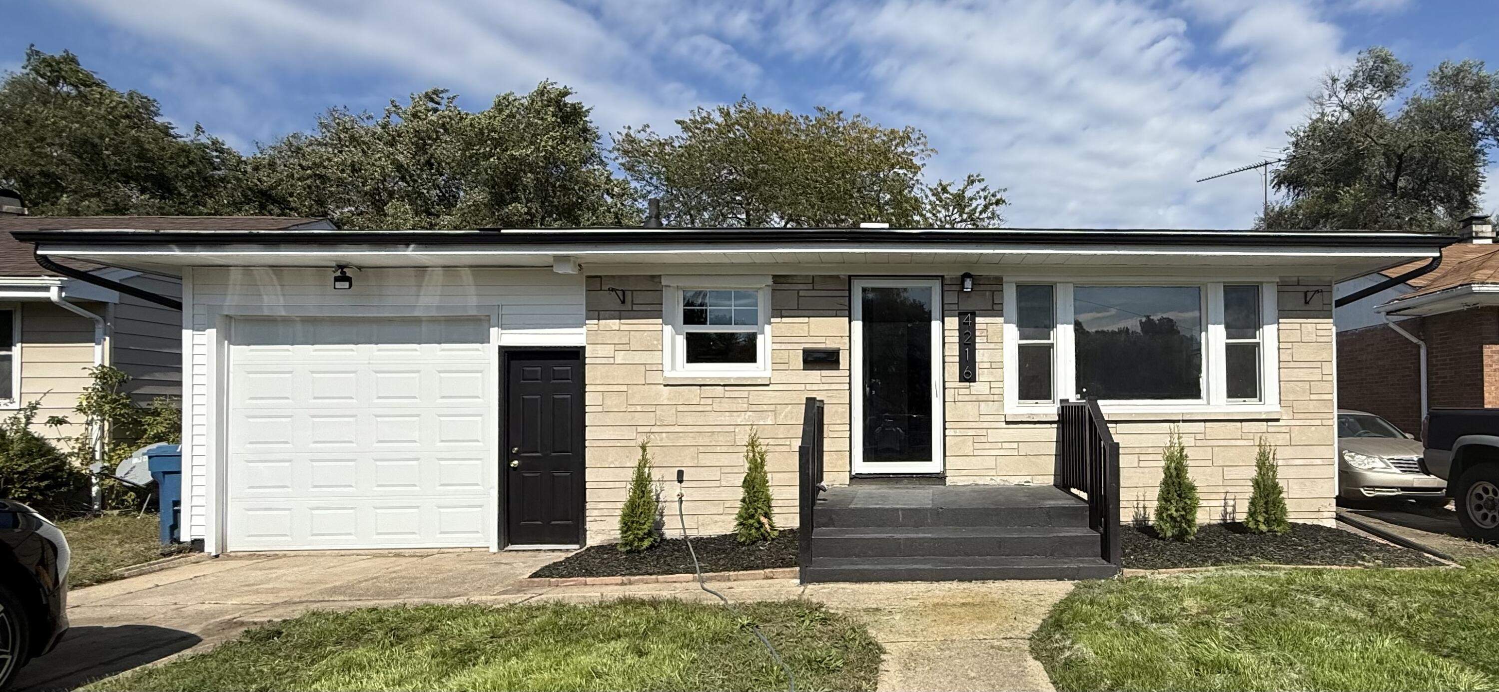 a front view of house with a garden