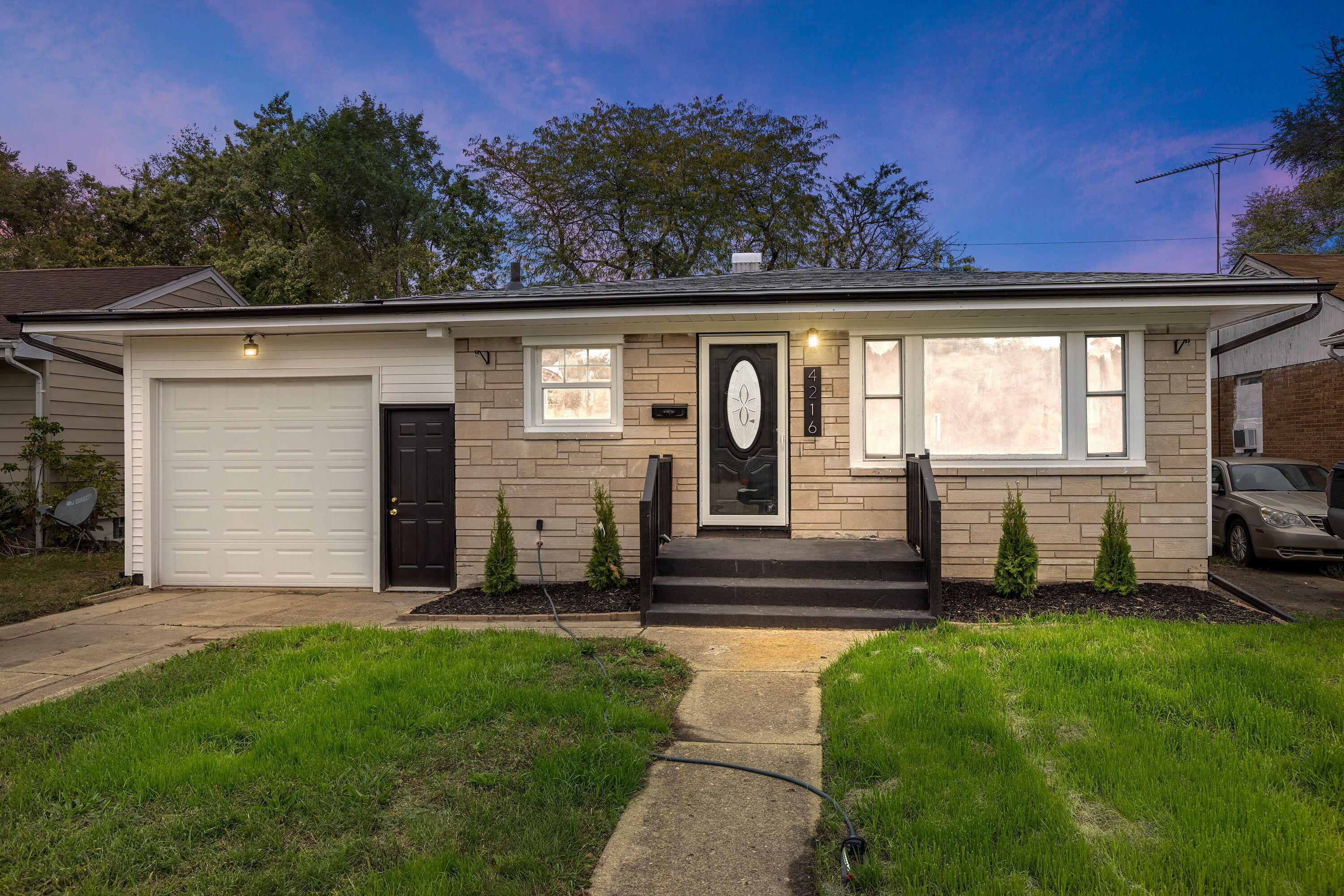 4216 East 13th Avenue Gary, IN 46403 - Photo 18 of 18 a front view of a house with garden