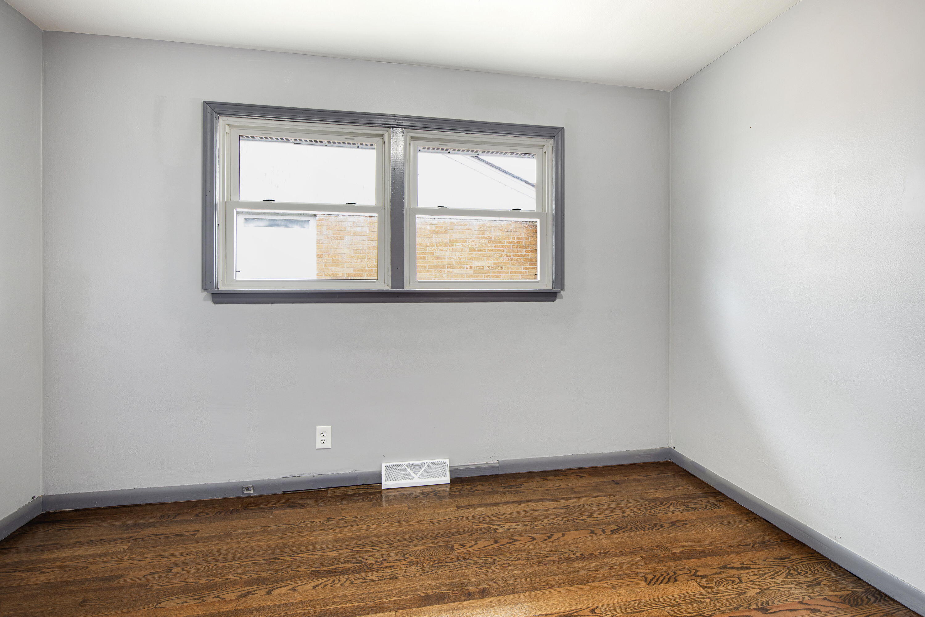 4216 East 13th Avenue Gary, IN 46403 - Photo 6 of 18 an empty room with wooden floor and windows