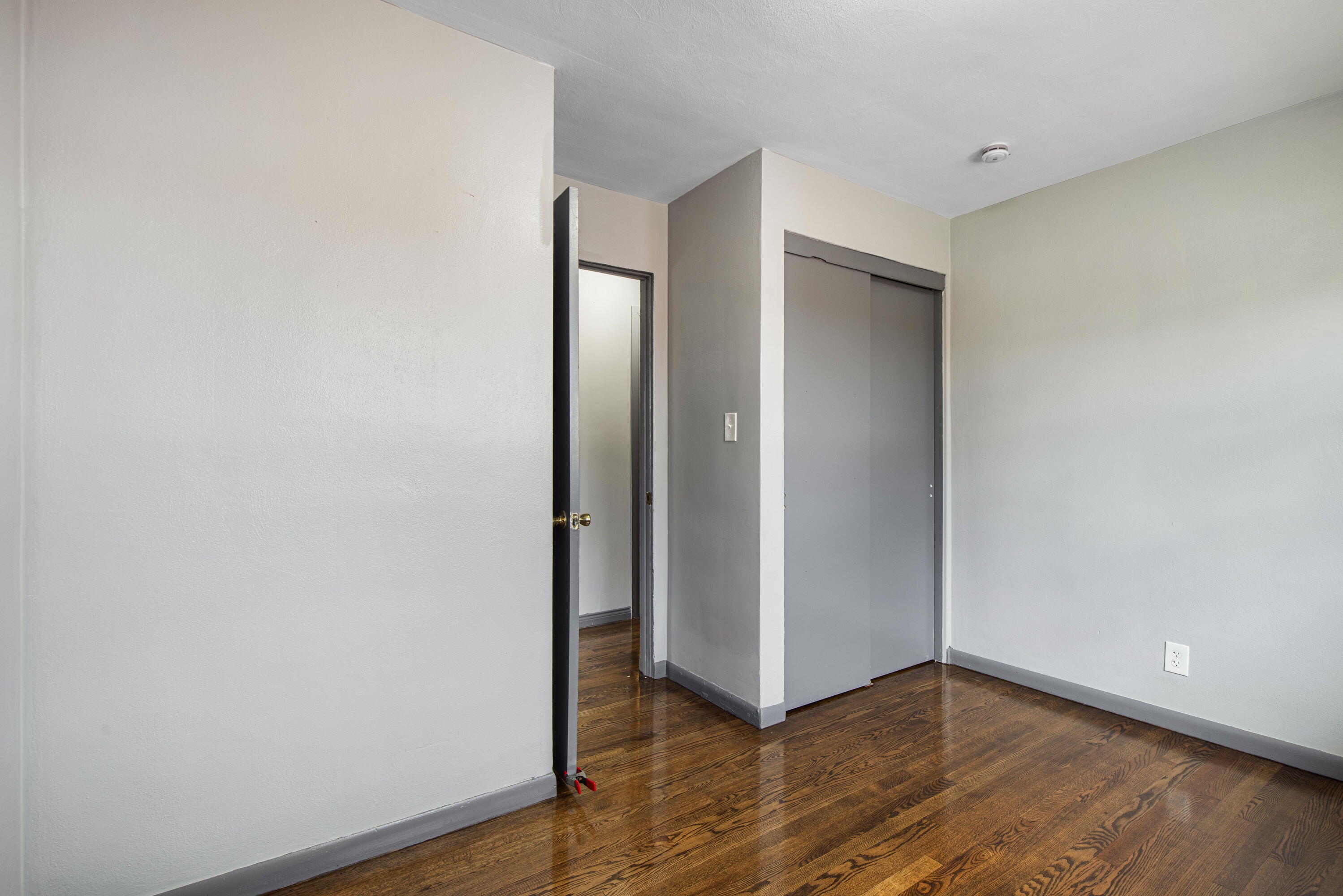 4216 East 13th Avenue Gary, IN 46403 - Photo 7 of 18 a view of an empty room with wooden floor and closet