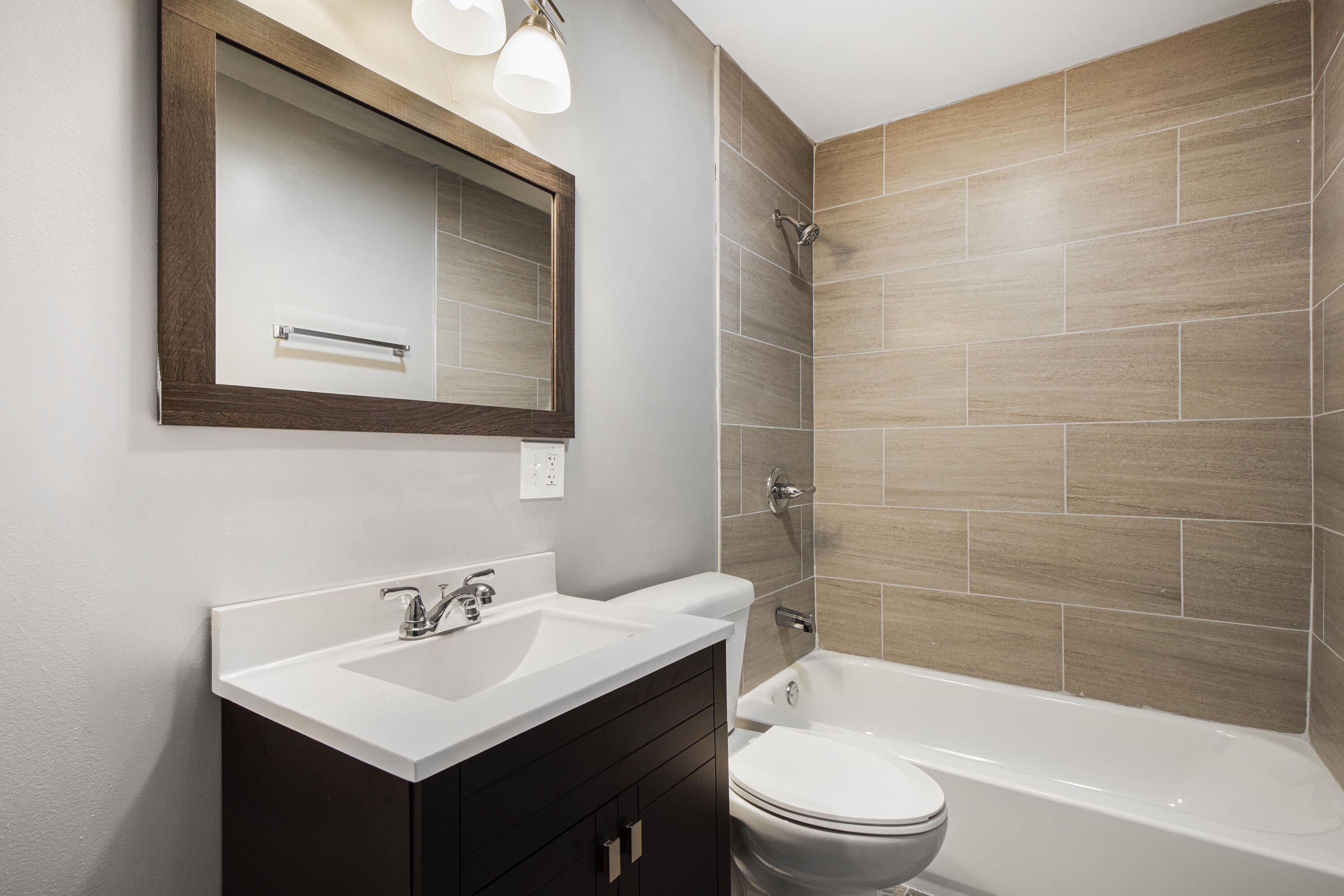 4216 East 13th Avenue Gary, IN 46403 - Photo 8 of 18 a bathroom with a sink a toilet and shower