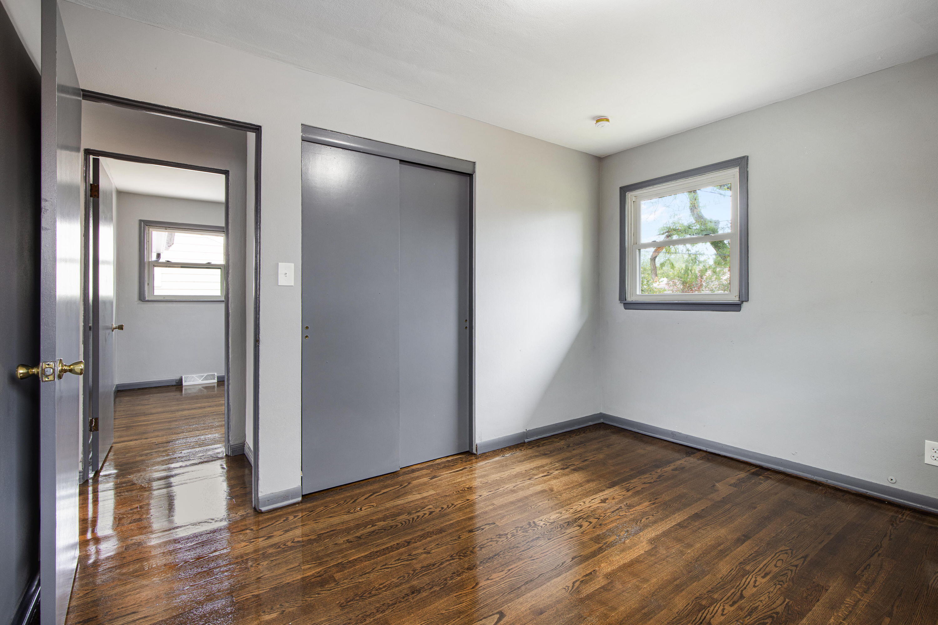 4216 East 13th Avenue Gary, IN 46403 - Photo 10 of 18 wooden floor in an empty room with a window