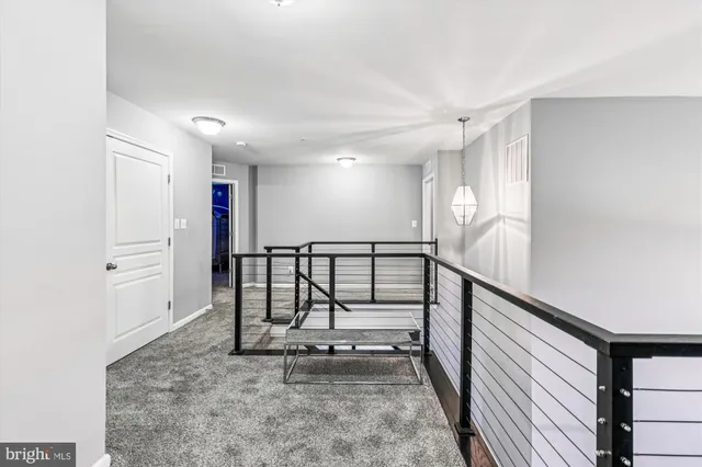 a bedroom with a bed chandelier and a dresser