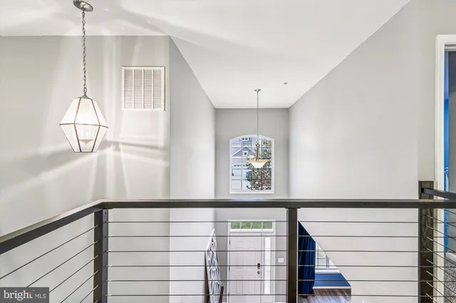 a bedroom with a bed chandelier and pink walls