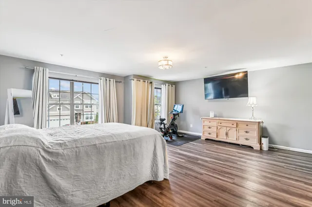 a bedroom with a bed dresser and a window