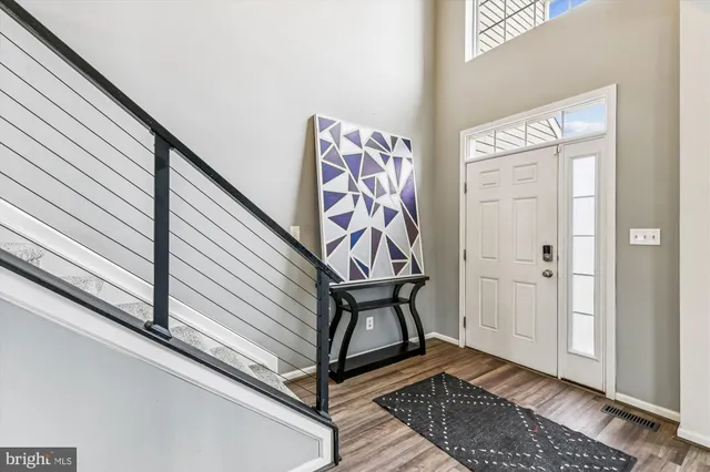 a view of an empty room window and wooden floor