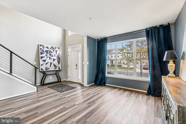 a dining room with furniture entryway and wooden floor