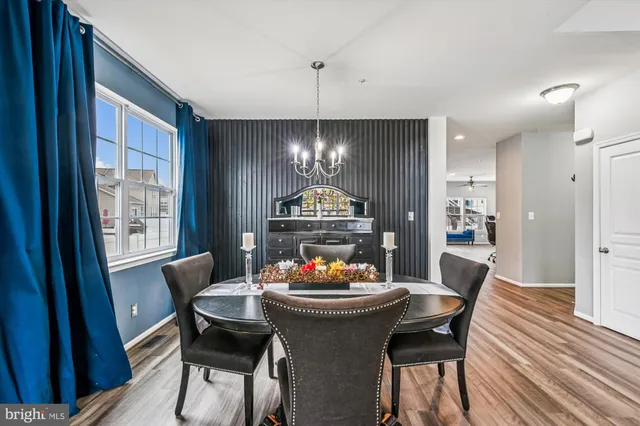 a living room with stainless steel appliances kitchen island granite countertop furniture and a wooden floors