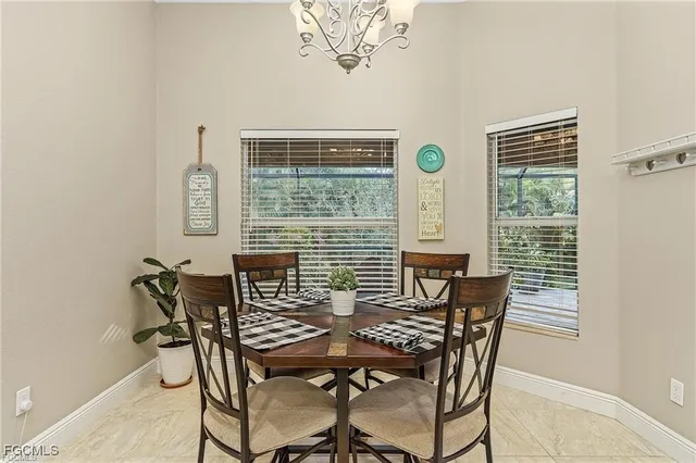 a view of a dining room with furniture and window