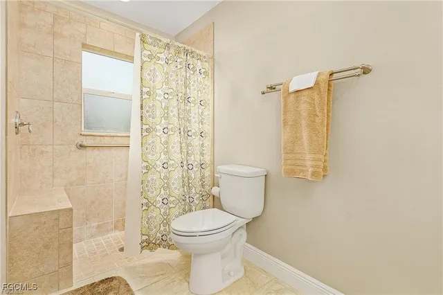 a bathroom with a toilet and shower