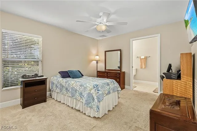 a bedroom with a bed and dresser with mirror