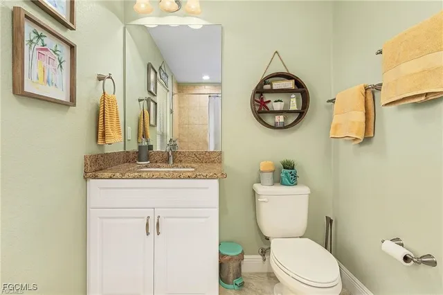 a bathroom with a toilet a sink and a mirror