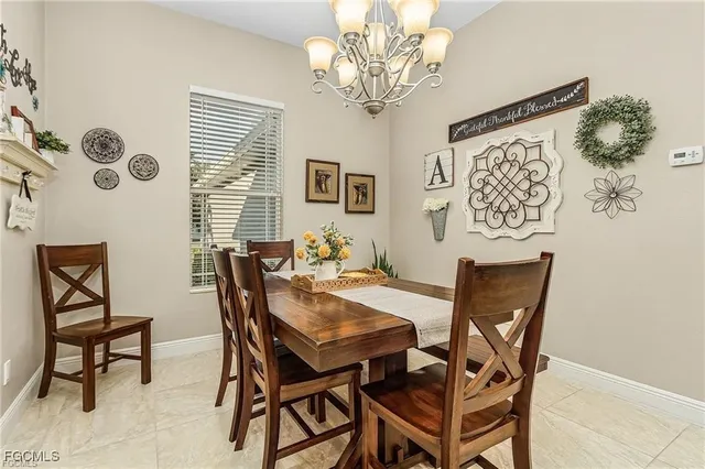 a view of a dining room with furniture and chandelier