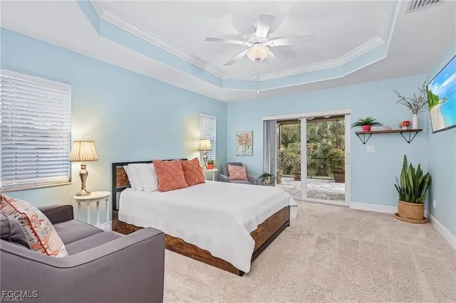 a spacious bedroom with a large bed and a chandelier