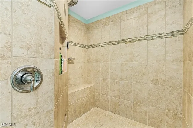 a bathroom with a sink a window and a shower