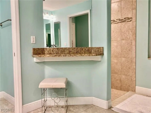 a view of bathroom with a sink and a mirror