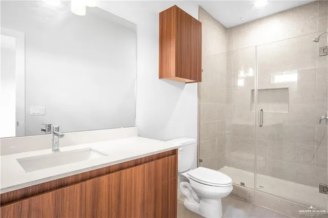 a bathroom with a sink a toilet and shower