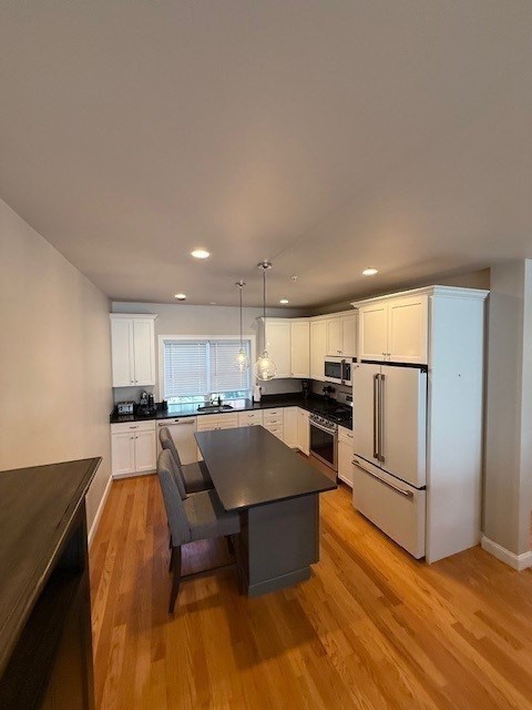 176 Main Street, Unit 3 Medway, MA 02053 - Photo 14 of 26 a living room with stainless steel appliances kitchen island granite countertop a refrigerator a stove a sink and a cabinets with wooden floor