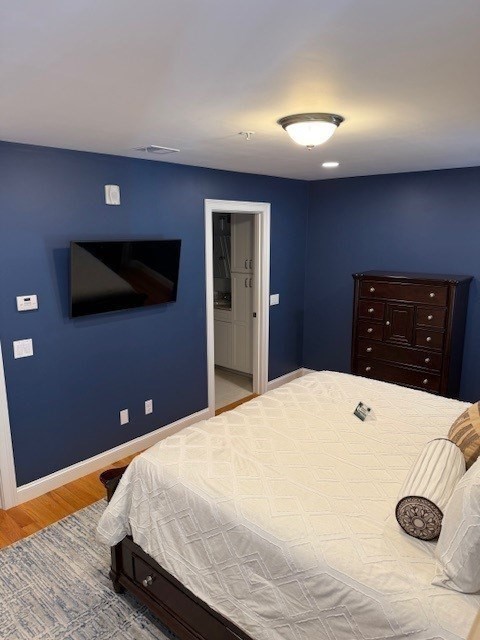 176 Main Street, Unit 3 Medway, MA 02053 - Photo 22 of 26 a bedroom with a bed and a flat screen tv