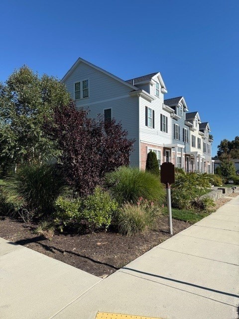 176 Main Street, Unit 3 Medway, MA 02053 - Photo 4 of 26 a front view of a house with a yard