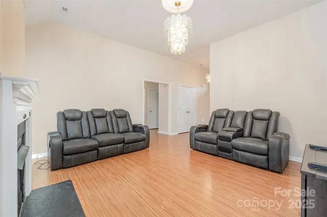 a living room with furniture and a chandelier